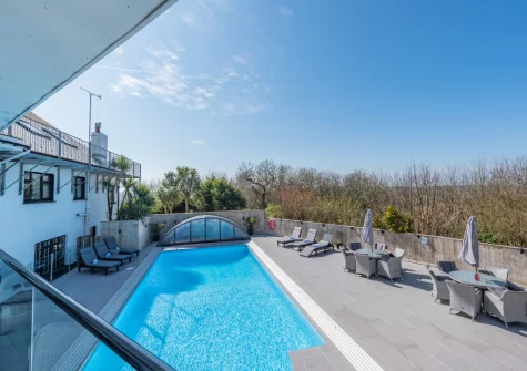 The all-weather outdoor heated swimming pool, alfresco dining & outdoor sitting area at Trebrowen, Angle