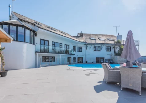 The all-weather outdoor heated swimming pool, alfresco dining & outdoor sitting area at Trebrowen, Angle