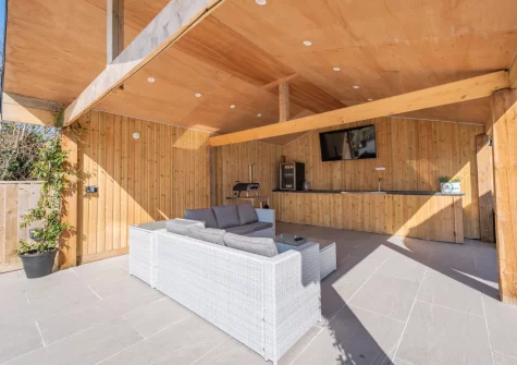 The sheltered seating area with outdoor bar & pizza oven at Trebrowen, Angle