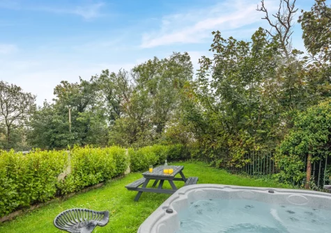 The alfresco dining area, hot tub & enclosed lawned garden at Tree Tops, St Florence