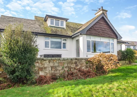 The small patio, outdoor sitting area & lawned garden at Ty Adda, Abersoch