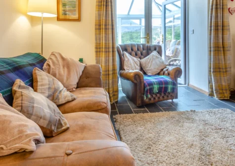 Ty Gwair, St Anns Bethesda is a beautifully converted barn boasting a private hot tub with breathtaking Snowdonia mountain views, three comfortable bedrooms, underfloor heating, and easy access to zip wires, waterfalls and castles across North Wales.