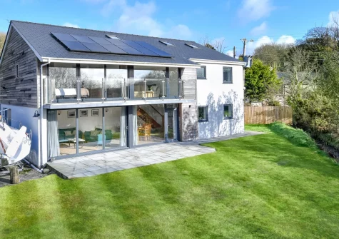 The large patio with barbecue, outdoor furniture & south-facing garden at Ty Nant, Llaniestyn