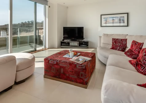 Ty Traeth, Tenby is a stunning beachfront apartment overlooking South Beach's golden sands, featuring a private balcony terrace with spectacular sea views, contemporary interiors with Sky Sports, and direct beach access just metres from your door.