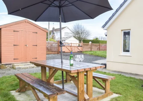 The alfresco dining area & enclosed lawned garden at Ty Twt, Clunderwen