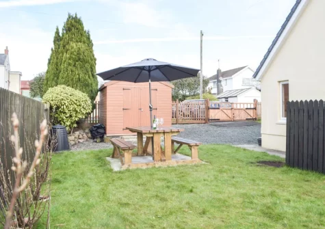 The alfresco dining area & enclosed lawned garden at Ty Twt, Clunderwen