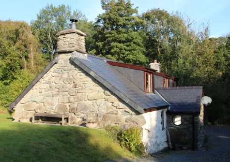 Ty'n Lon Isaf is surrounded by a large garden bordered by the upper reaches of the Hirgwm River