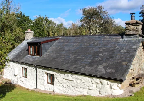 Ty'n Lon Isaf is surrounded by a large garden bordered by the upper reaches of the Hirgwm River