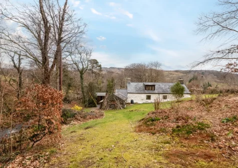 Ty'n Lon Isaf is surrounded by a large garden bordered by the upper reaches of the Hirgwm River