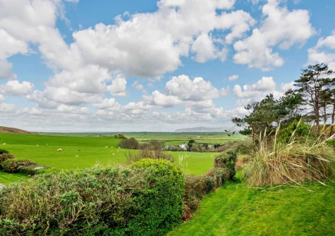 The countryside view from the patio, barbecue & outdoor sitting area at Ty'n Y Mur Cottage, Abersoch