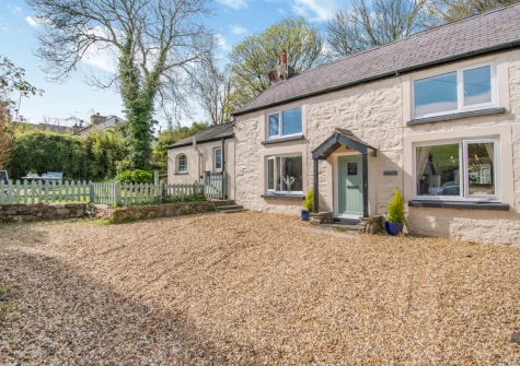 Tyr Wennol is a chocolate box cottage, with a wood burner ,in an idyllic village setting