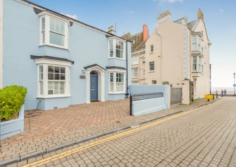 With its seaside-blue fa√ßade, Vine Cottage has been lovingly restored to create a fantastic holiday home-away-from-home