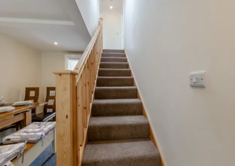The dining room & stairs up to the first floor at Vista Sol, Aberdovey