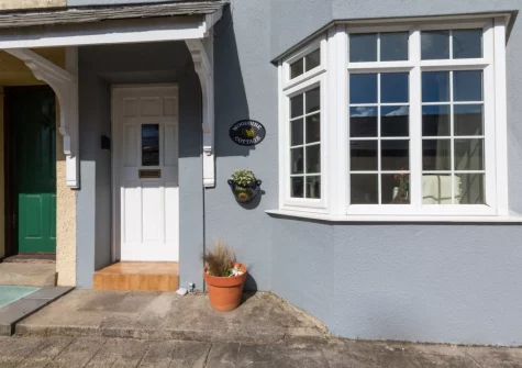 Woodbine Cottage is a spacious and characterful family home with distant sea views