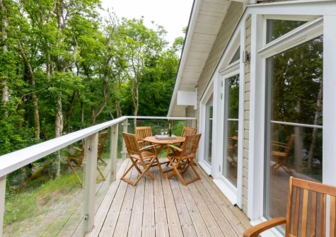 The glass-fronted balcony & outdoor sitting area at Woodland View, Trefloyne Manor, Penally