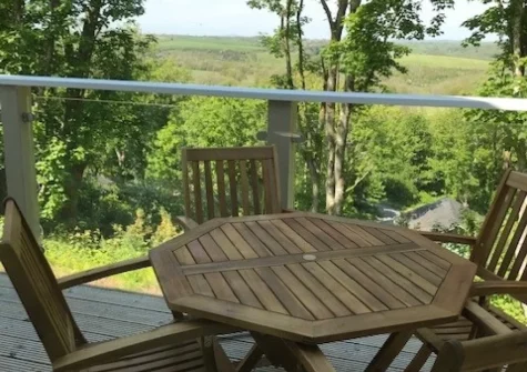 The glass-fronted balcony & outdoor sitting area at Woodland View, Trefloyne Manor, Penally
