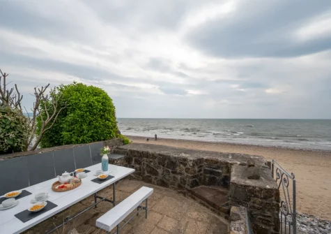 The patio & alfresco dining area, with gate giving you direct access to the beach, at Wren Cottage, Saundersfoot