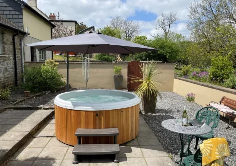 The rear patio, hot tub & outdoor sitting area at Y Beudy, Clynderwen