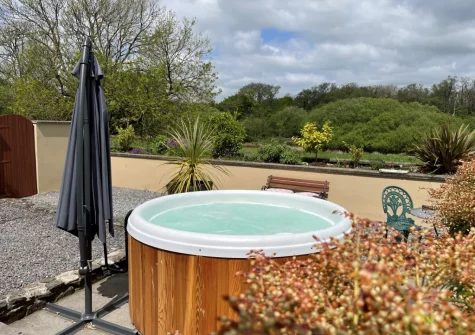 The rear patio & hot tub at Y Beudy, Clynderwen