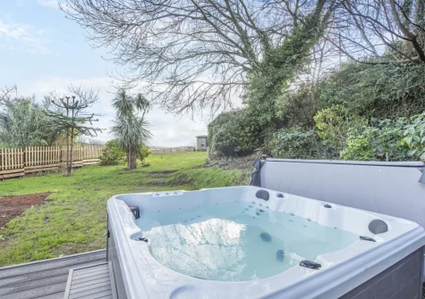 The decked patio, hot tub & enclosed garden at Y Llanw, Milford Haven