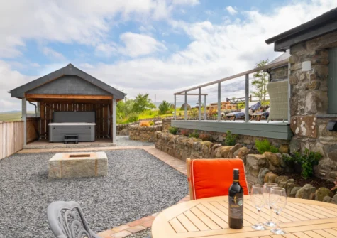 The alfresco dining are, fire pit & hot tub at Ynys Cadno, Trawsfynydd