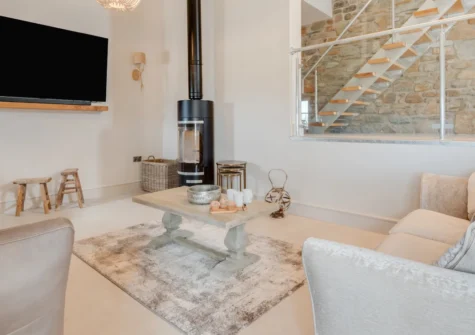 Ynys Cadno, Trawsfynydd is a stunning barn conversion sleeping six, boasting a private hot tub, cosy wood burner and sunny decked terrace with truly breathtaking panoramic views across Snowdonia National Park's magnificent mountain scenery.