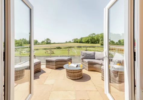 Step out on the patio & outdoor sitting area at Yr Hen Barlwr, Talwrn