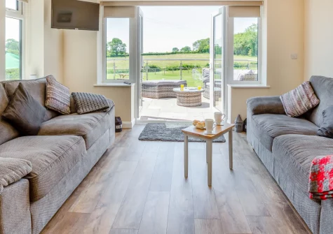 Yr Hen Barlwr, Talwrn is a beautifully renovated farm cottage near Llangefni, boasting a wood burner, courtyard garden with Snowdonia views, flexible bedrooms, and easy access to Anglesey's beaches, castles and coastal attractions across the island.