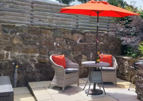 The patio, barbecue & outdoor sitting area at Yr Hen Ysgubor, Sarn Meyllteyrn