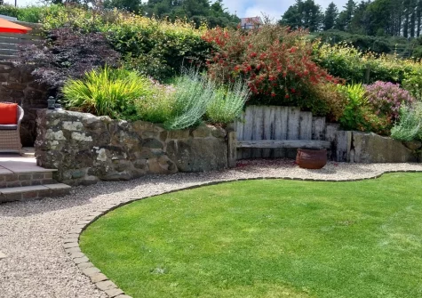 The firepit, outdoor sitting area & enclosed lawned garden at Yr Hen Ysgubor, Sarn Meyllteyrn